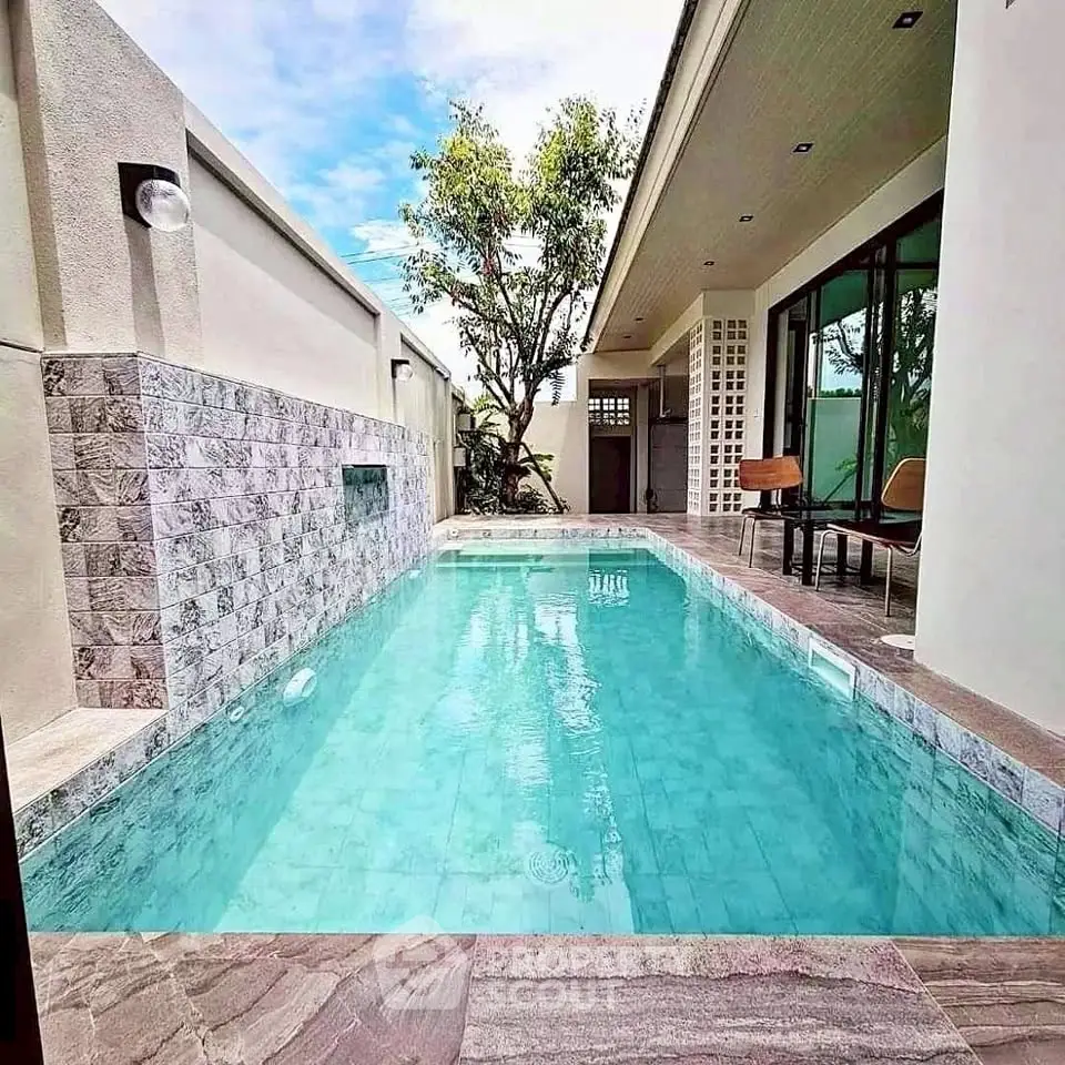 Luxurious modern home with private pool and elegant patio area.