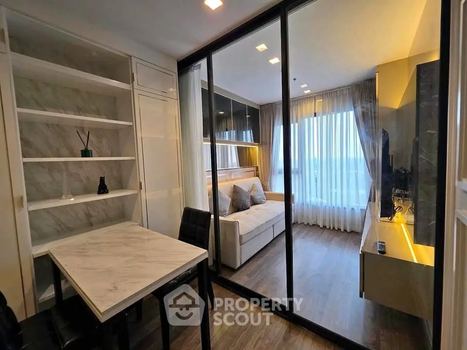 Modern living room with glass partition and stylish decor