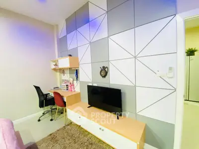 Modern living room with geometric wall design and sleek furniture