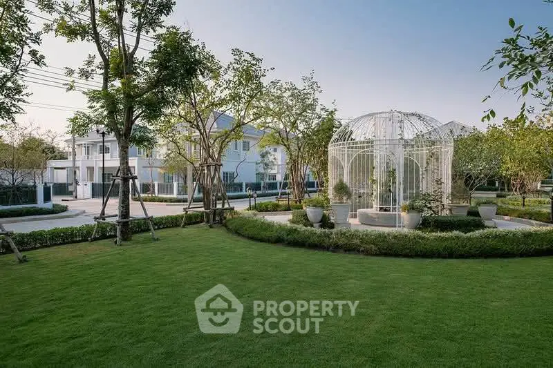 Elegant residential garden with gazebo and lush greenery in a serene neighborhood setting.