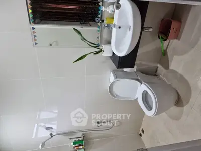 Modern bathroom with sleek fixtures and a minimalist design.