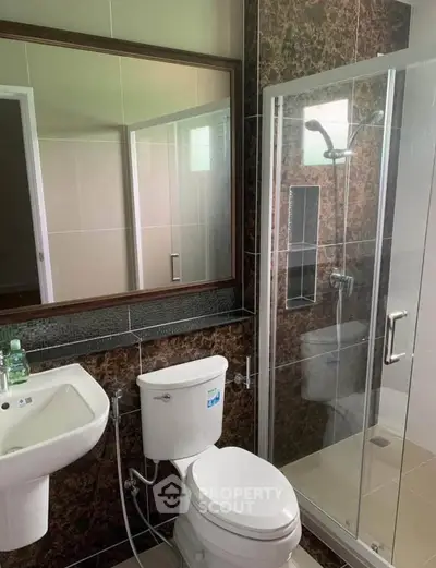 Modern bathroom with glass shower and elegant tile design