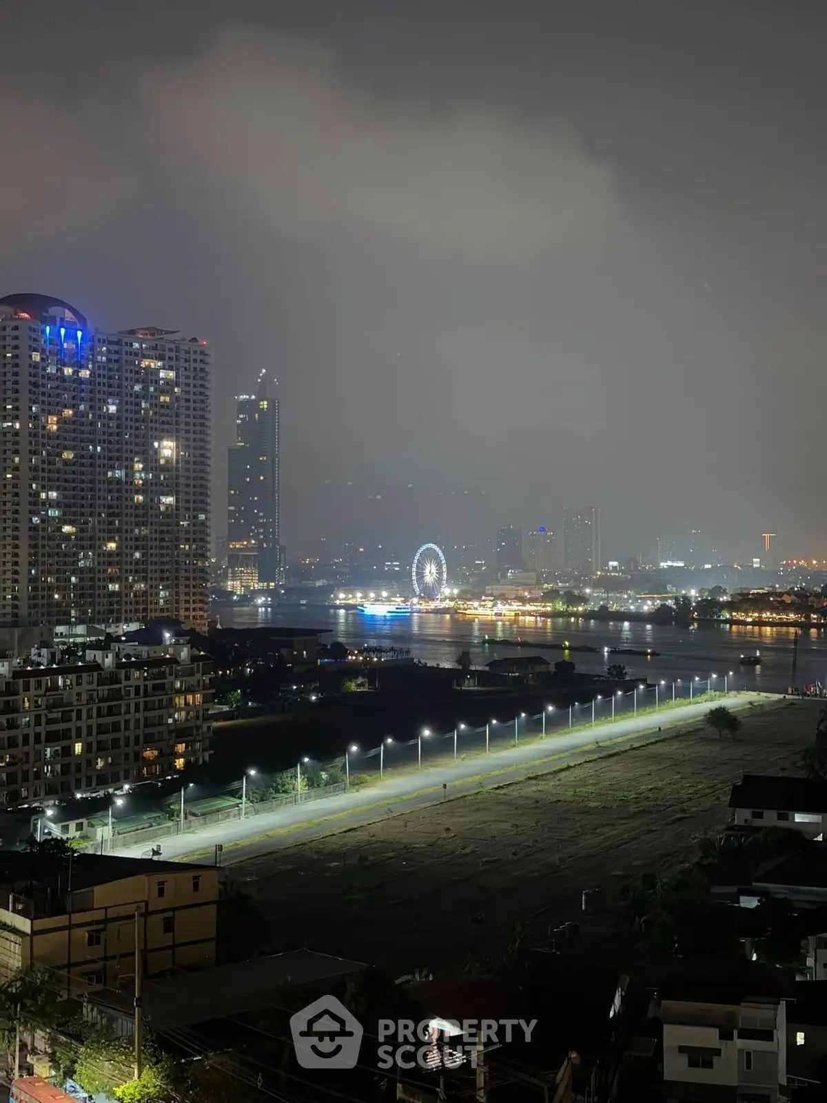 Stunning cityscape view with illuminated skyline and river at night