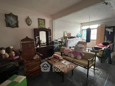 Cozy living room with eclectic decor and natural light, perfect for relaxation and family gatherings.