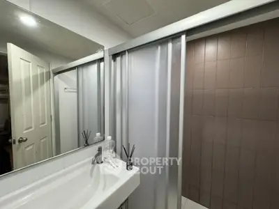 Modern bathroom with sleek sink and large mirror