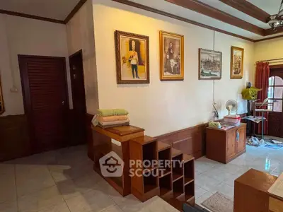 Charming living room with wooden accents and vintage decor, featuring elegant wall art and cozy atmosphere.