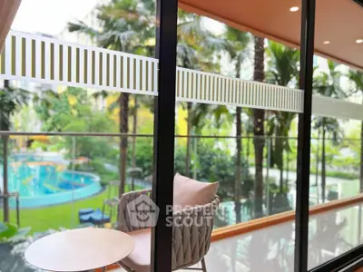 Luxurious balcony view overlooking lush garden and pool, perfect for relaxation and leisure.