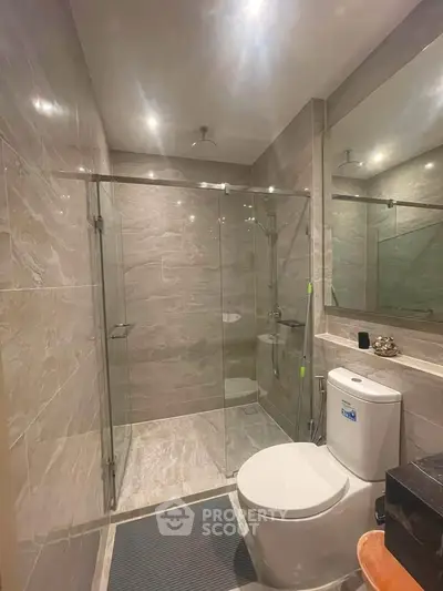 Modern bathroom with glass shower and sleek tile design