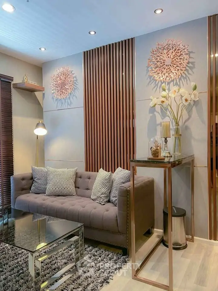 Elegant living room with modern decor, plush sofa, and stylish wall art, perfect for contemporary urban living.
