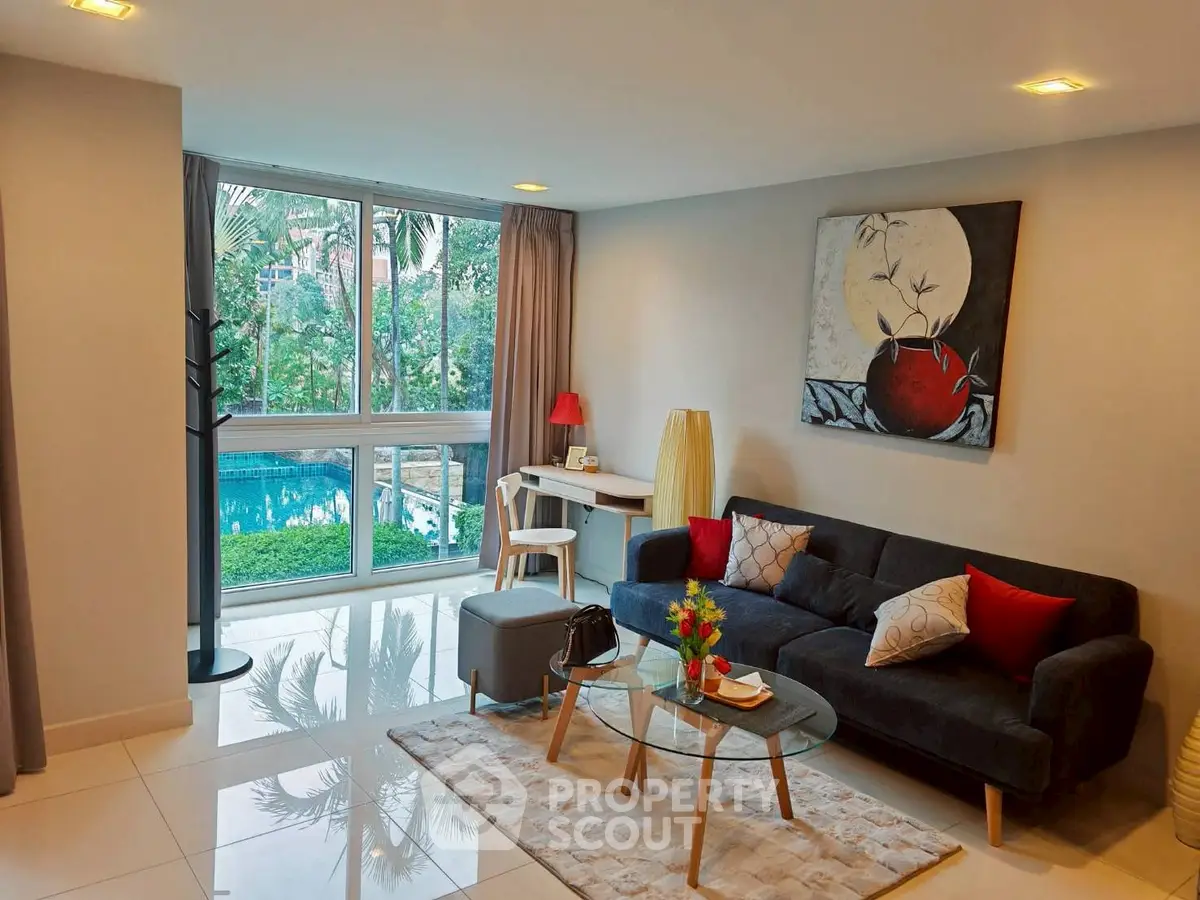 Modern living room with pool view, stylish decor, and natural light