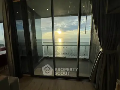 Stunning ocean view from a modern apartment balcony at sunset.