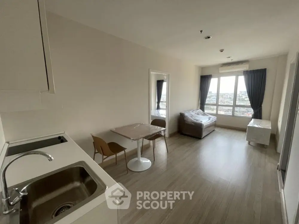 Modern apartment living room with open kitchen and city view