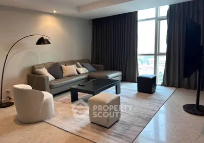 Modern living room with stylish furniture and large window view