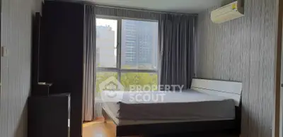 Modern bedroom with large window and air conditioning in urban apartment