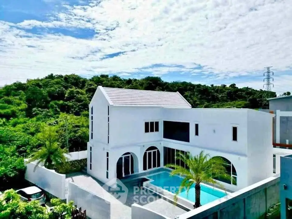 Stunning modern villa with private pool and lush greenery views.