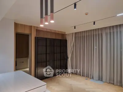 Modern living room with elegant lighting and floor-to-ceiling curtains