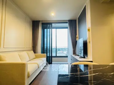 Modern living room with elegant decor and large window offering a stunning view.