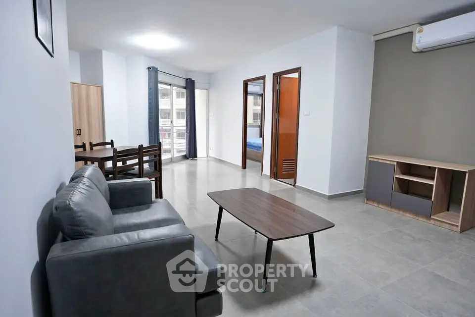 Spacious modern living room with sleek furniture and ample natural light