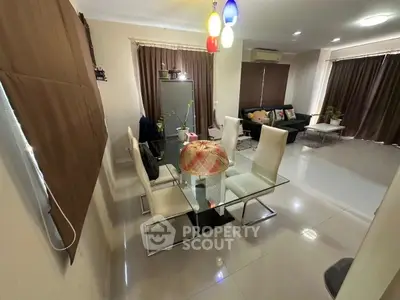 Spacious modern living and dining area with stylish furniture and natural light.