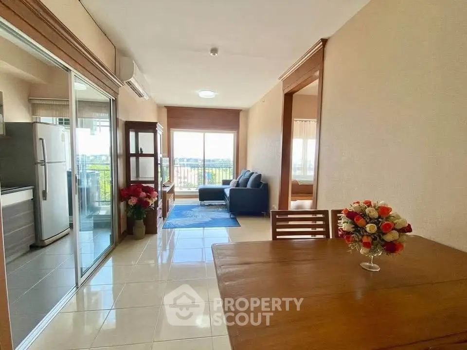 Spacious open-plan living area with modern kitchen and balcony view