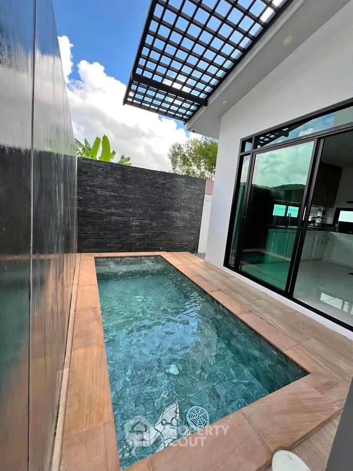 Modern private pool with sleek design and glass sliding doors, perfect for luxury living.