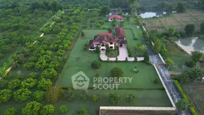 Stunning aerial view of luxurious estate with expansive green gardens and elegant architecture