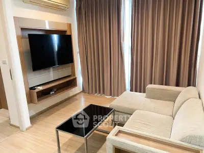Modern living room with sleek TV setup and cozy beige sofa, perfect for relaxation.