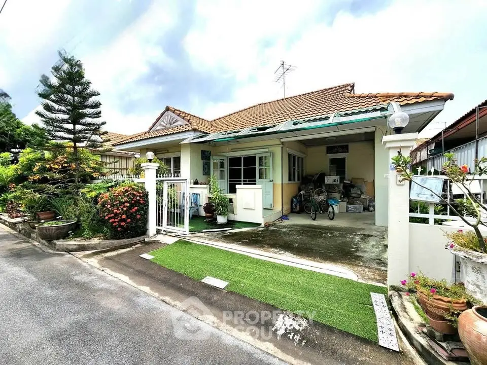 Charming single-story home with lush garden and spacious driveway in a serene neighborhood.