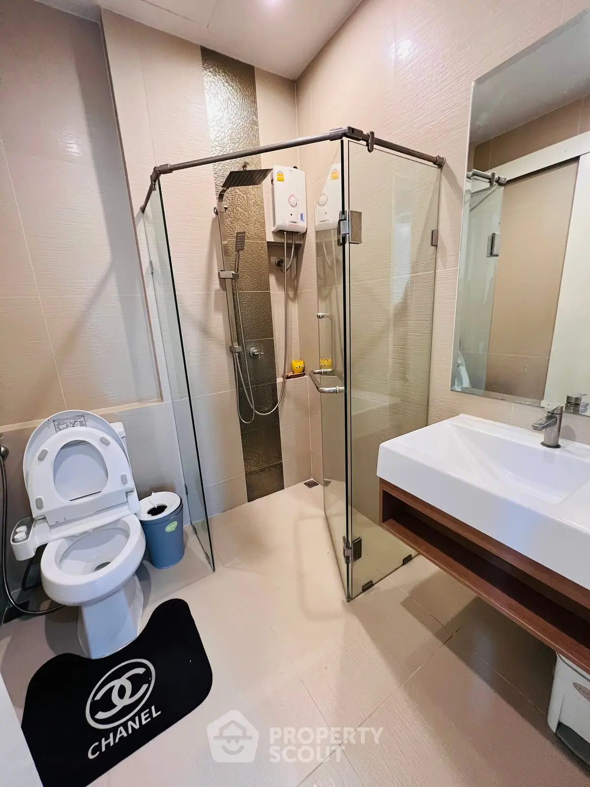 Modern bathroom with glass shower enclosure and stylish fixtures