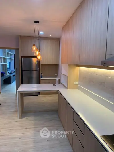 Modern kitchen with sleek cabinetry and stylish pendant lighting