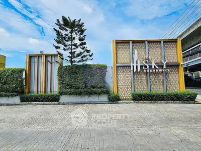 Modern entrance of The Sky Sukhumvit with lush greenery and stylish design.