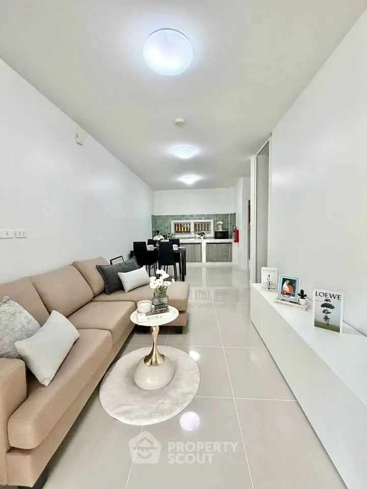 Modern open-plan living room with sleek kitchen and stylish decor
