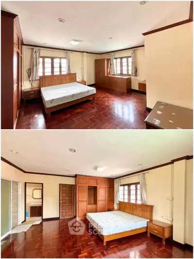 Spacious bedroom with wooden flooring and ample natural light