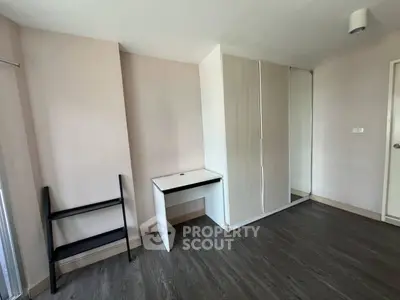 Spacious bedroom with sleek wardrobe and modern flooring