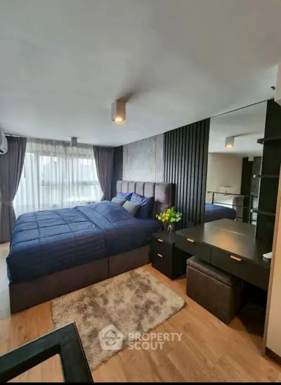 Luxurious bedroom with modern decor and plush bedding in a stylish apartment.