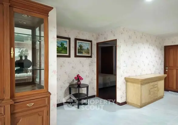 Charming hallway with floral wallpaper and elegant wooden furniture