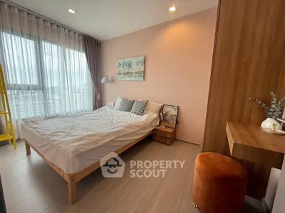 Modern bedroom with large window and stylish decor in urban apartment