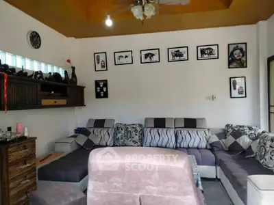 Spacious living room with modern decor and ample seating, perfect for family gatherings.