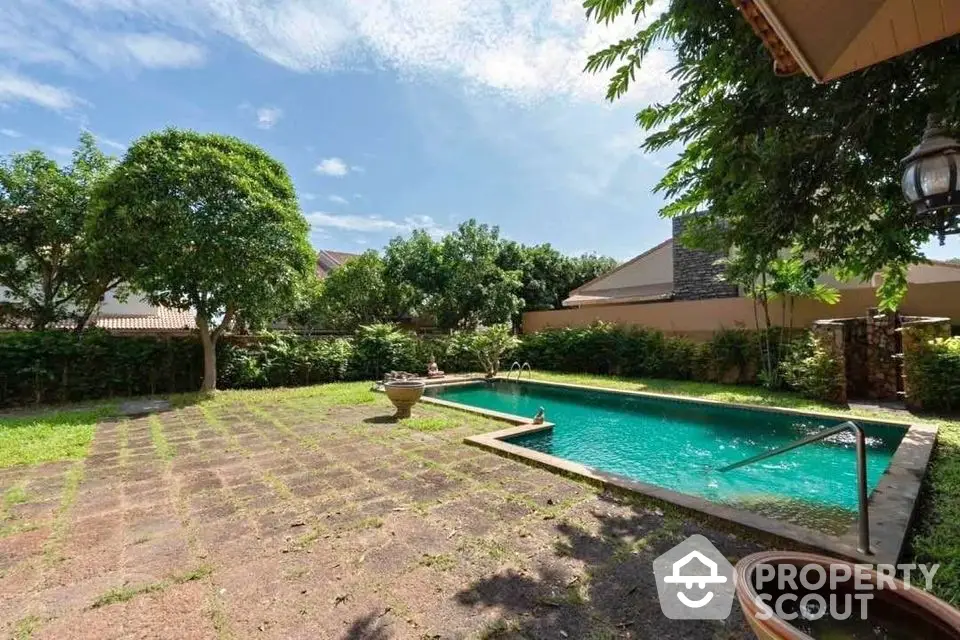 Spacious backyard with private swimming pool and lush greenery