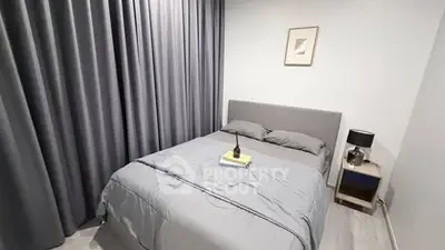 Modern bedroom with stylish decor and cozy ambiance, featuring a comfortable bed and elegant curtains.