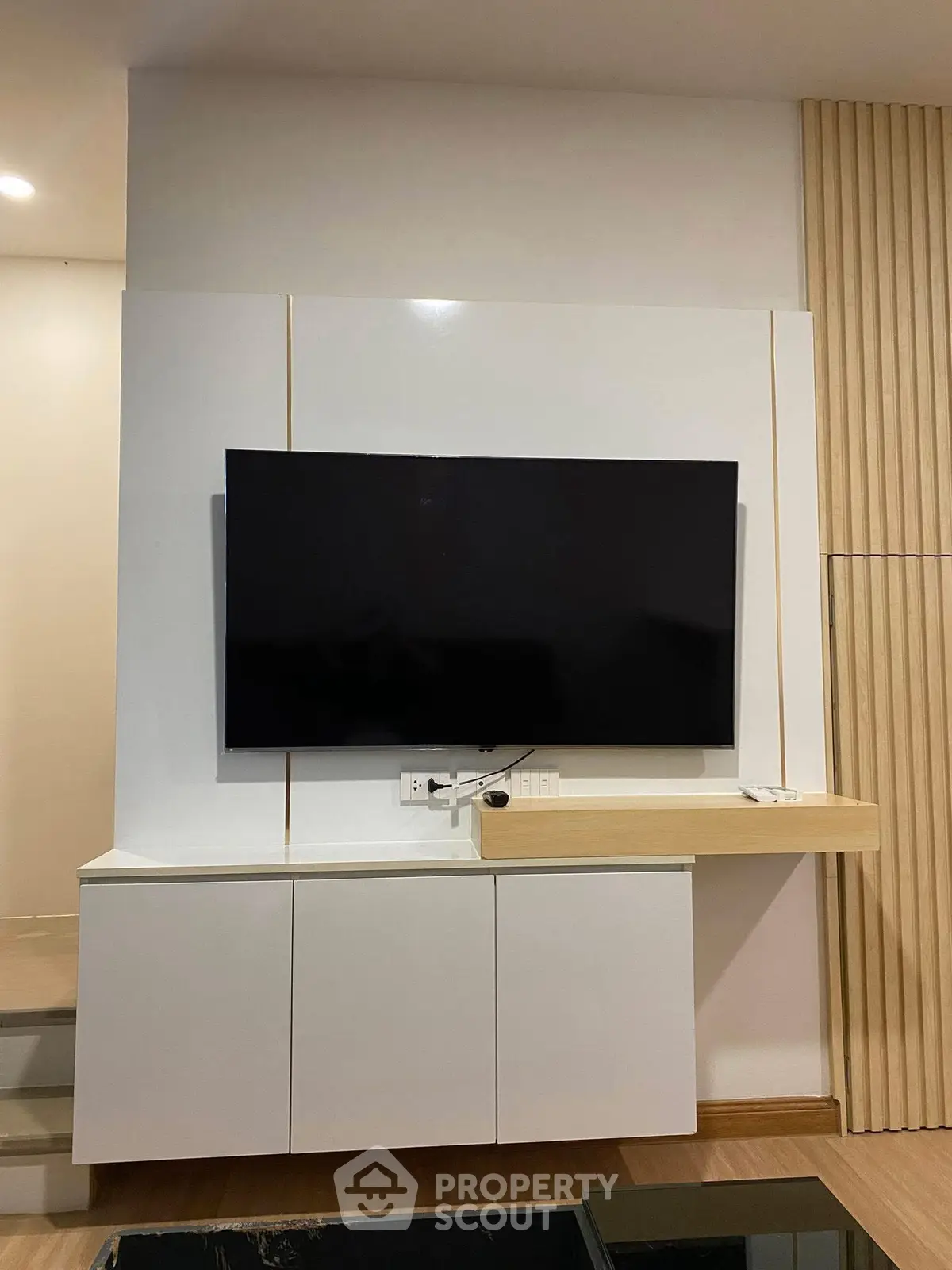 Modern living room with sleek TV unit and stylish wooden paneling