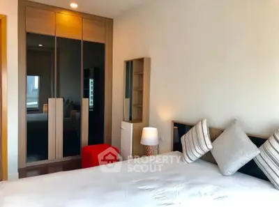 Modern bedroom with stylish decor and ample natural light