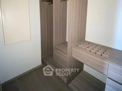 Spacious walk-in closet with wooden shelving and ample storage space.