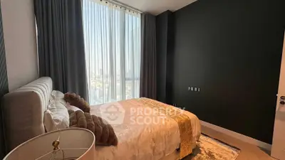 Luxurious bedroom with floor-to-ceiling windows and elegant decor in modern apartment.