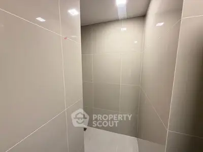 Minimalist bathroom with sleek tiled walls and modern lighting