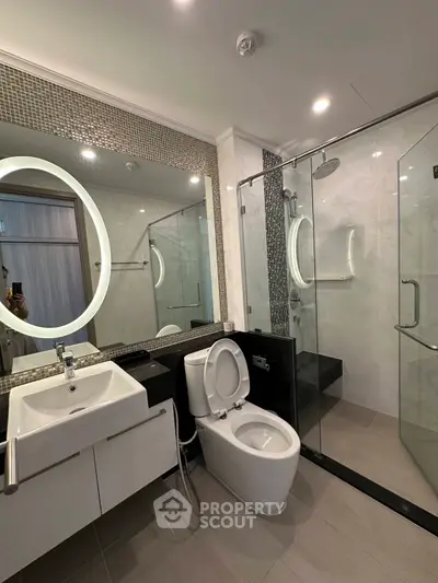 Modern bathroom with sleek fixtures and glass shower enclosure