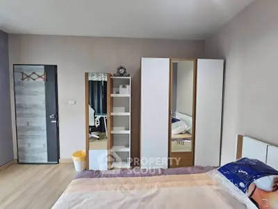 Spacious bedroom with modern wardrobe and cozy decor