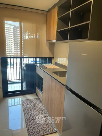 Modern kitchen with sleek appliances and city view from window
