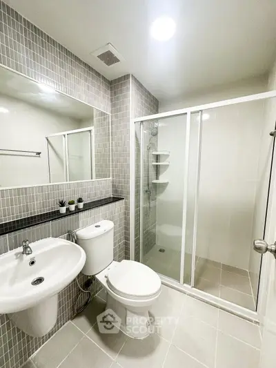 Modern bathroom with sleek shower and stylish fixtures in a contemporary apartment.