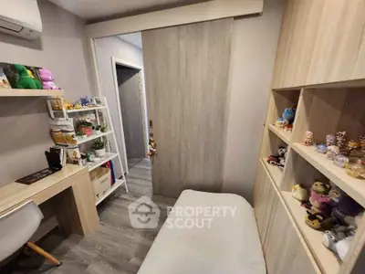Cozy study room with modern decor and ample shelving for collectibles